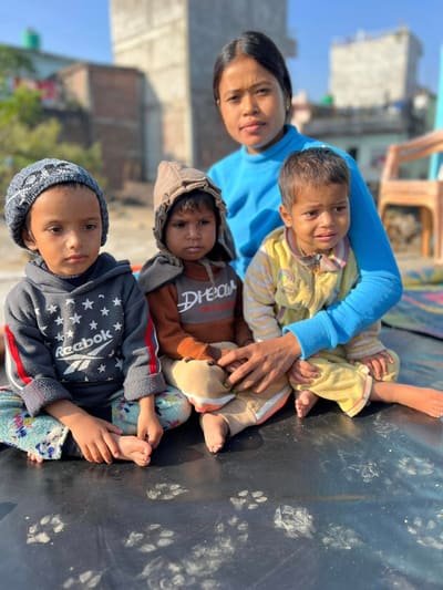 A caregiver with children at Sahara Ghar