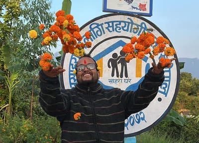 Founder Bal Bahadur Bista celebrating with marigolds at the home