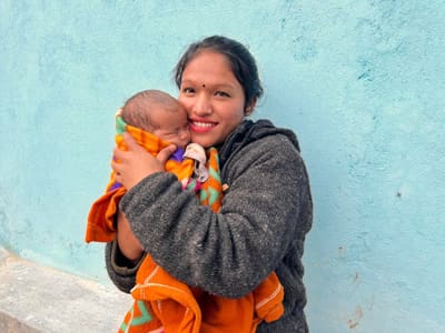 A young mother with her newborn at Sahara Ghar